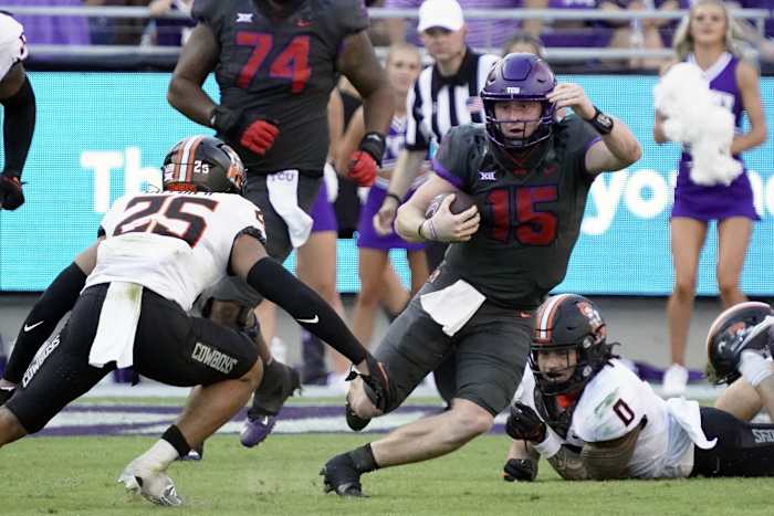 TCU Horned Frogs quarterback Max Duggan (15) looks to rush past Oklahoma State Cowboys safety Jason Taylor II (25) during the second half at Amon G. Carter Stadium.